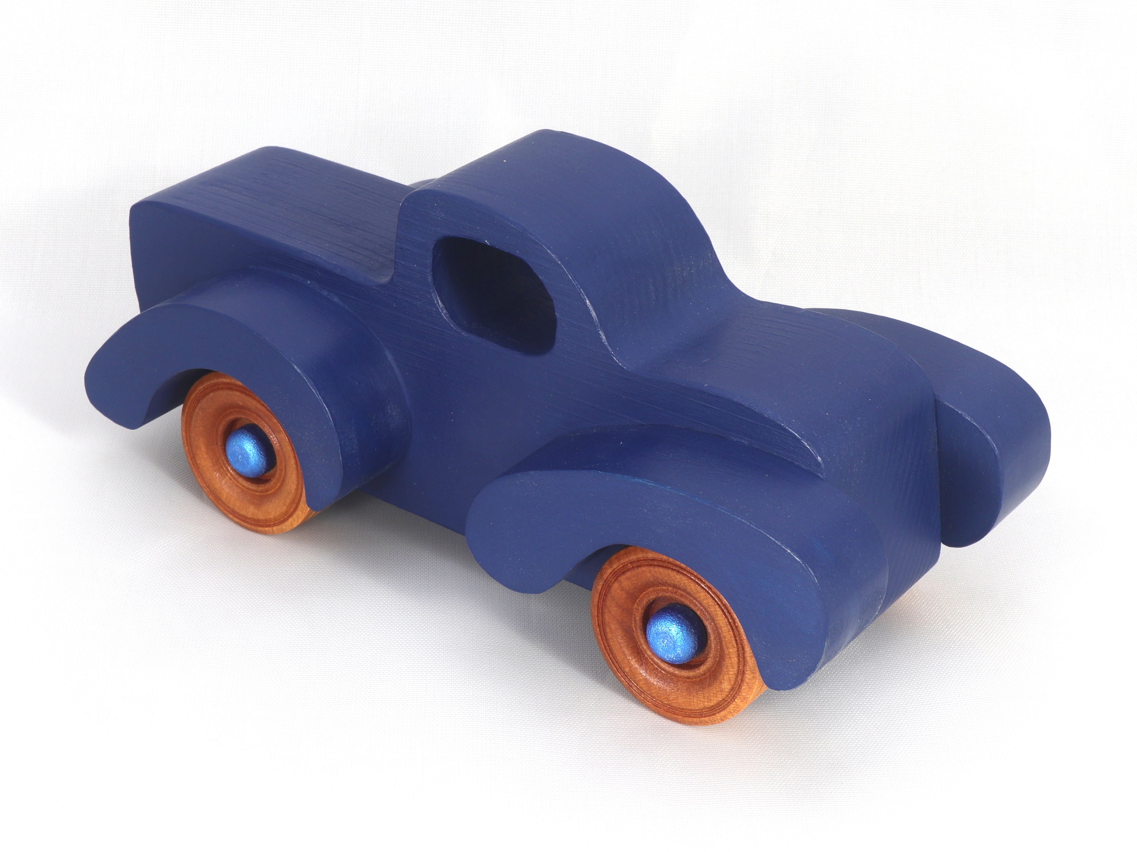Toy Pickup Truck With Fat Fenders HandA handmade wooden toy pickup truck with large fenders, painted in nontoxic navy blue and metallic sapphire blue and finished with non-marring amber shellac on the wheels.made and Painted Navy Blue