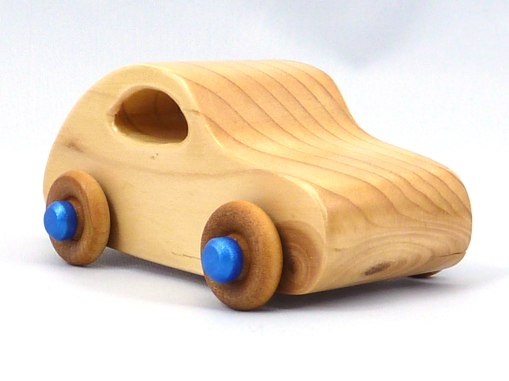 Handmade wood toy car based on the 1957 Bug with a satin polyurethane finish, metallic sapphire blue trim, and nonmarring amber shellac wheels. Made to Order.