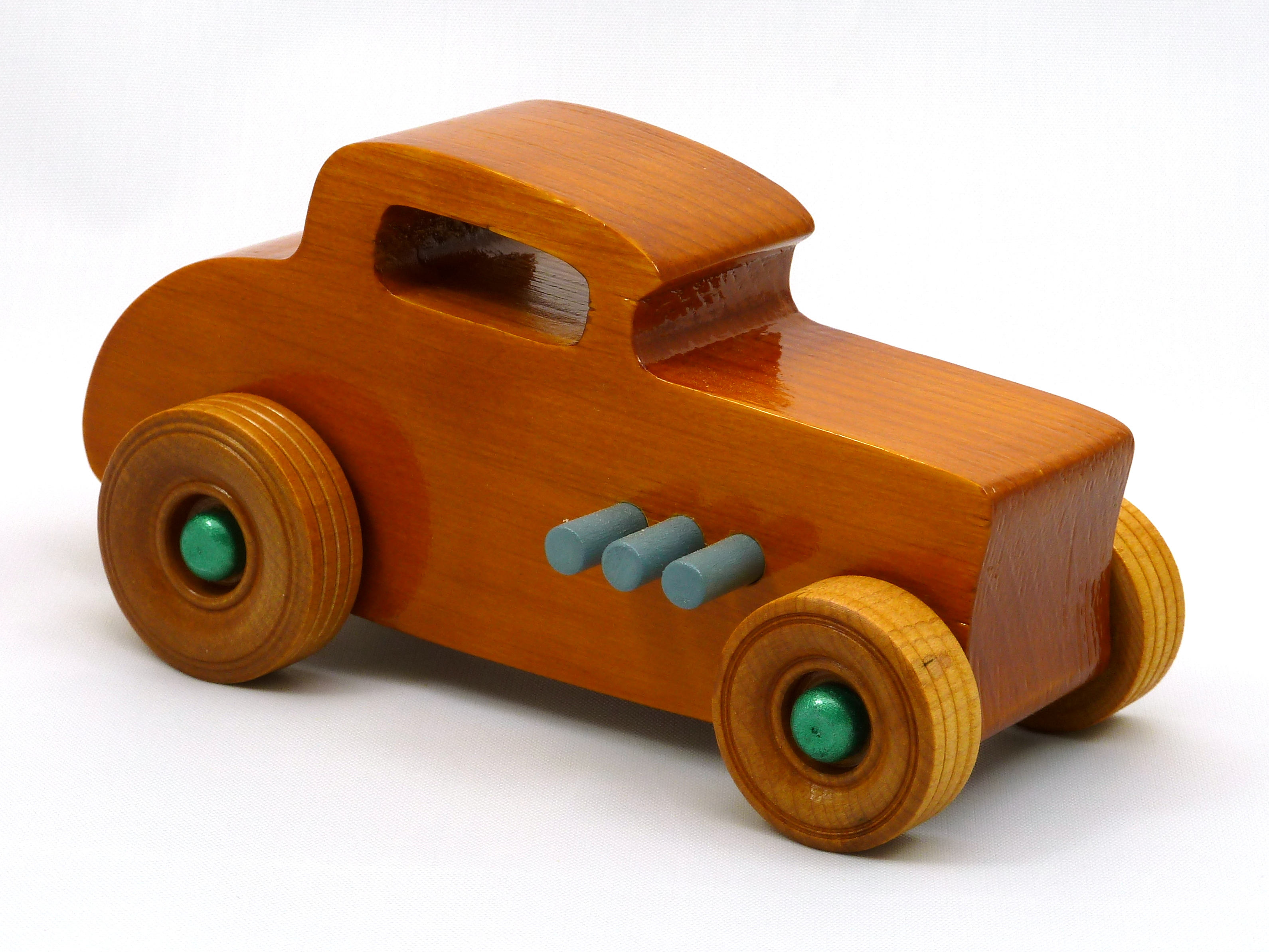 Handmade wooden toy car hot rod 32 deuce coupe with an amber shellac finish and metallic emerald green and gray trim. Perfect for kids or adults.