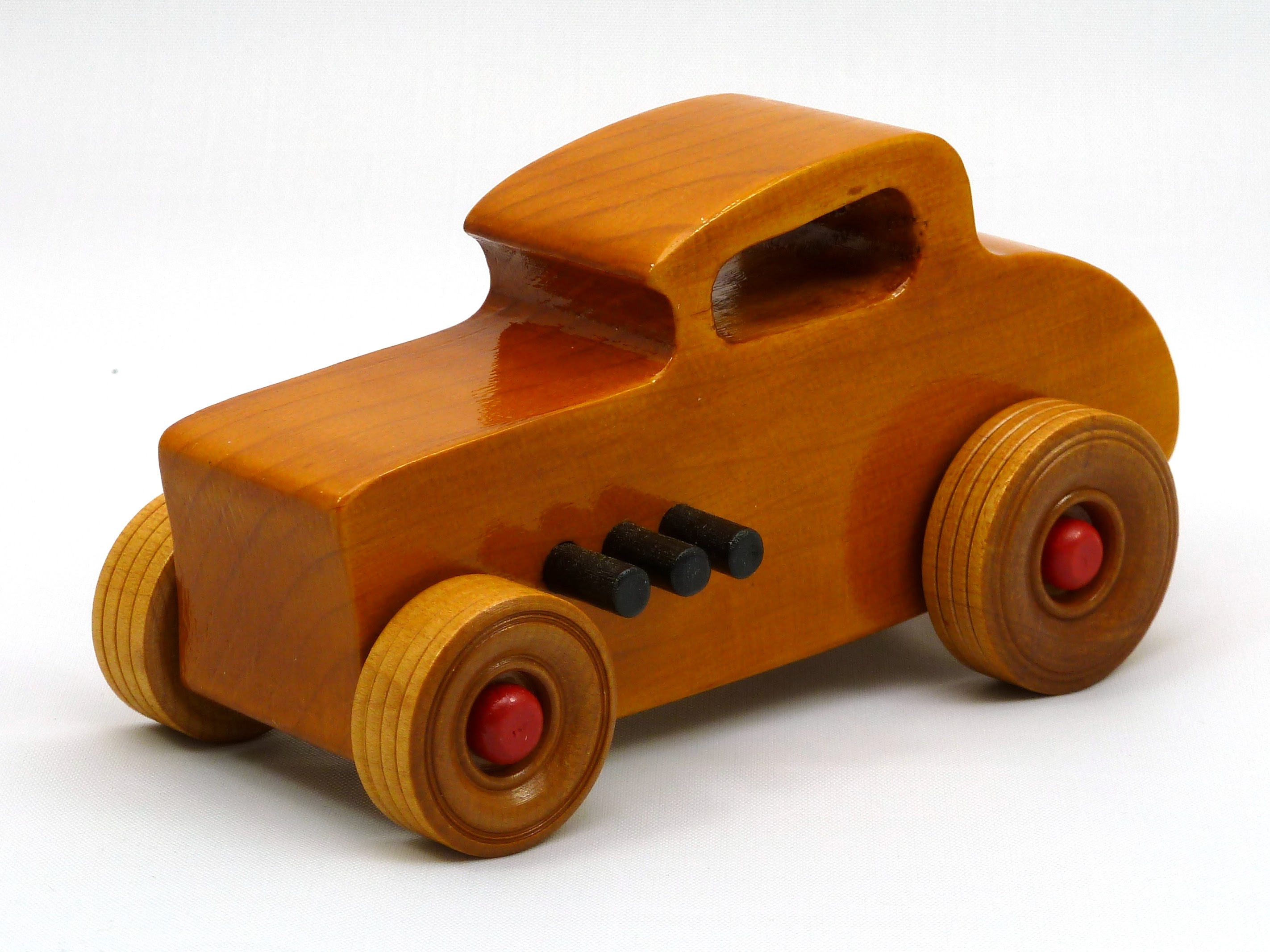 Handmade wooden toy car hot rod 1932 Deuce Coupe amber shellac finish with red and black acrylic paint trim.